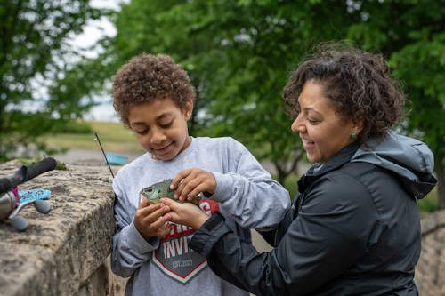 Child with fish - Card image